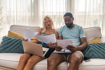 Two young people, couple in relationship, working together at home office. Startup new global...