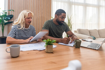 Two young people, couple in relationship, working together at home office. Startup new global...