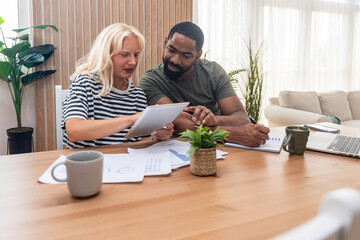 Two young people, couple in relationship, working together at home office. Startup new global...