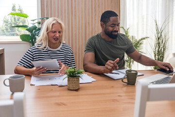 Two young people, couple in relationship, working together at home office. Startup new global...