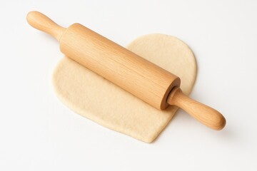 A baking scene featuring a rolling pin and dough on a clean white surface