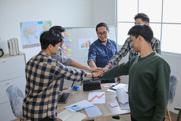 College Students With Teacher Showing Unity With Hands Stacked In Teamwork Gesture