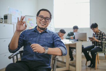 Portrait Of Confident Teacher Or Professional Showing Approval In Classroom