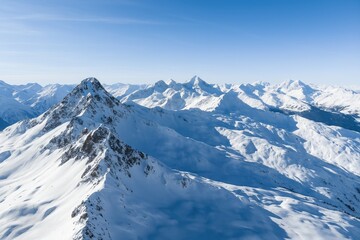 Aerial view of snow-covered mountain tops in the French Alps close to a ski area
