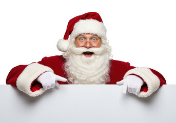 A cheerful santa claus with a white beard and hat points down at a blank white sign, isolated on a transparent background