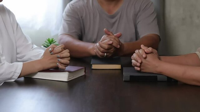 Sacred Study Diverse Hands Holding Religious Text | Quiet Reflection Close-up of Reading Holy Book | Spiritual Connection Devotee Engaged with Sacred Scripture
