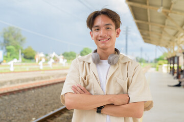 Young non binary tourist traveler in train station