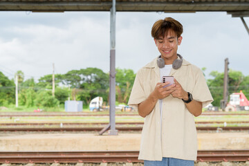 Young non binary tourist traveler in train station