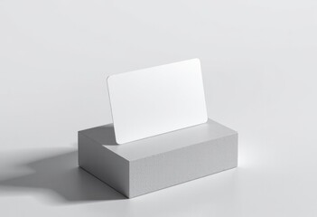 Blank white card on gray pedestal