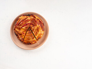 Vegan nectarine peach cake on white table, summer fruit pie