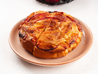 Vegan nectarine peach cake on white table, summer fruit pie