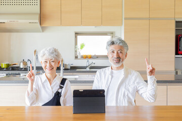 一緒にタブレットを使うシニアカップル