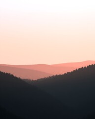 Layers of forest mountains at dawn