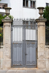 Old Gates in Historic European City. Ancient city gates with weathered stone and intricate details, ideal for history, travel, and heritage branding © Uladzimir