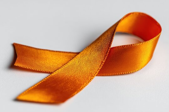 Orange ribbon isolated on white, orange ribbon symbolizes awareness of kidney cancer, leukemia, malnutrition, Attention Deficit Hyperactivity Disorder (ADHD) and multiple.