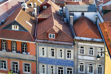 Ribeira District Rooftops and Colorful Facades in Porto, Portugal. Traditional tiled roofs and vibrant facades of historic houses in Porto’s Ribeira district, a UNESCO heritage site on the Douro River