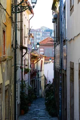 Fototapeten Narrow Streets of Ribeira Old Town in Porto, Portugal. Charming narrow streets of Porto’s Ribeira old town with colorful facades, historic atmosphere, and authentic Portuguese urban life. © Uladzimir