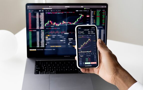 Person Checking Stock Market Data on Smartphone