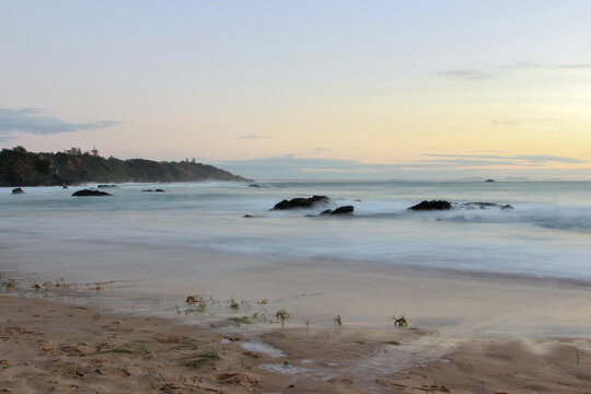 Waves washing over the rocks at a beach in the early morning