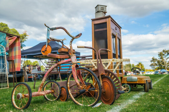 A collection of old trikes at a swap meet