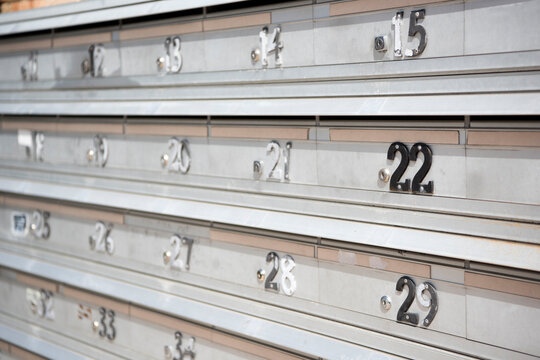 apartment block aluminium mailboxes with worn numbers
