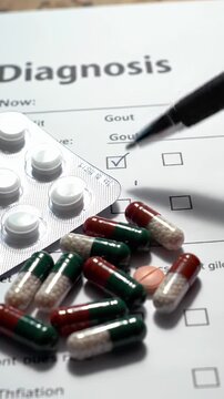 Close Up of Gout Diagnosis Form with Pen Pills and Capsules for Clinical Assessment in Bright White Background
