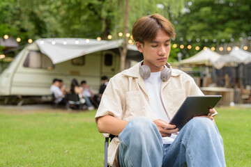Young non binary person having road trip and camping with friends in nature