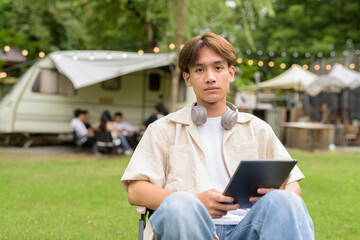 Young non binary person having road trip and camping with friends in nature