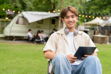 Young non binary person having road trip and camping with friends in nature