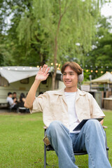 Young non binary person having road trip and camping with friends in nature