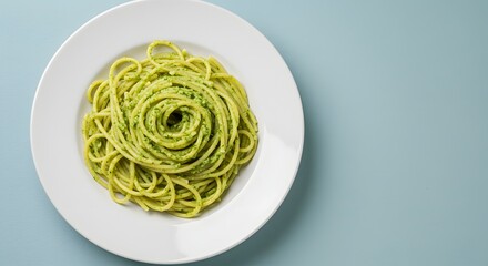 Plate Of Fresh Green Pasta Twirled Together On A Light Blue Background