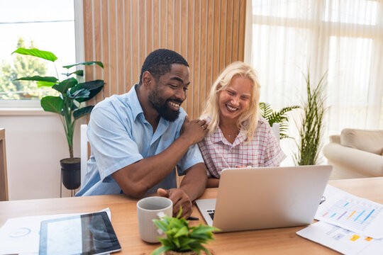 Finance and economy. Young couple, small business owners, working online at home office, having video call for presentation and online coaching. E-commerce man and woman professional occupation - Powered by Adobe