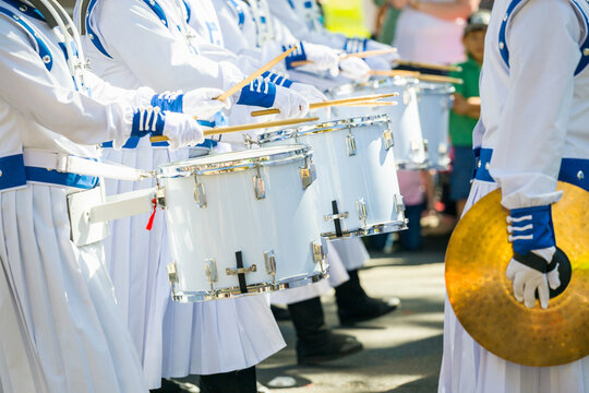 A row of drummers in a marching band