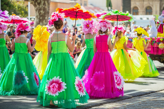 Ladies in colourful dresses in a parade