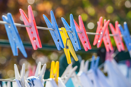 Clothes pegs holding laundry on a line