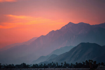 breathtaking summer sunset over majestic mountains reflecting vibrant hues of orange pink and purple in sky