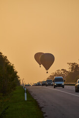 Hot Air Balloons Ascending Over Highway