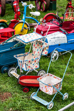 A collection of vintage prams, strollers and bikes