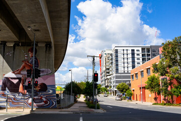 Street art under an overpass beside intersection