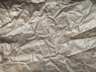 Vintage background from heavily crumpled paper, which is used as a wrapper. The texture of...