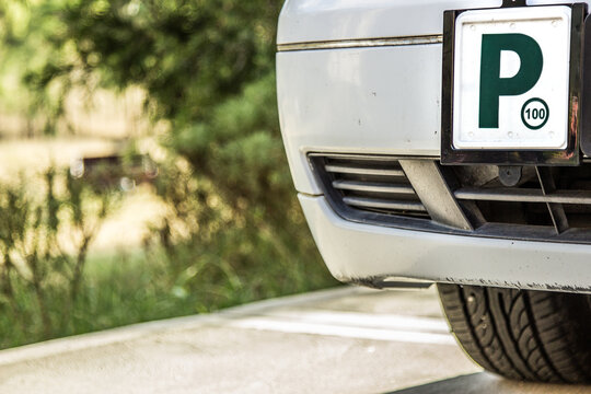 Green P2 license plate on the front of a car
