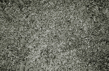 Rough textured surface creating a grunge background with black and white tones