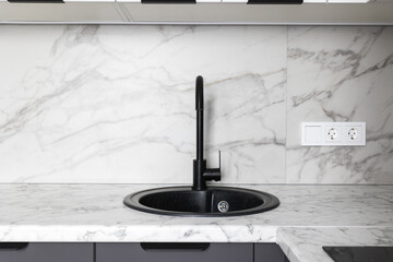 kitchen faucet on a stylish metal sink