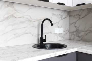 kitchen faucet on a stylish metal sink