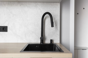 kitchen faucet on a stylish metal sink
