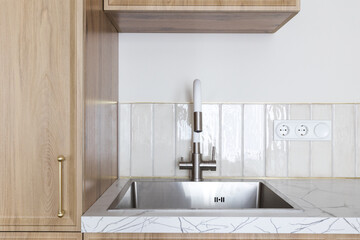 kitchen faucet on a stylish metal sink