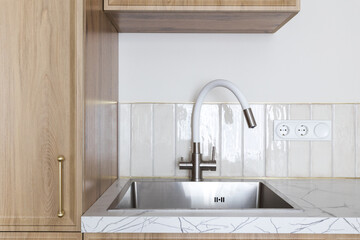 kitchen faucet on a stylish metal sink