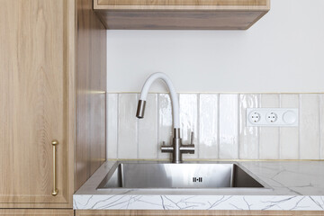 kitchen faucet on a stylish metal sink