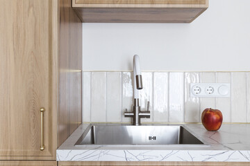 kitchen faucet on a stylish metal sink