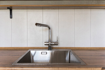 kitchen faucet on a stylish metal sink